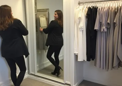 Professional tailor hemming a dress with precision scissors near Manchester City Centre